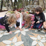 Kids inspecting John Botica's Frangipani artwork